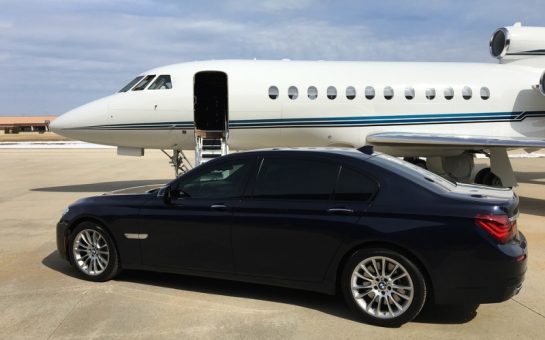 A private jet with a car parked in front