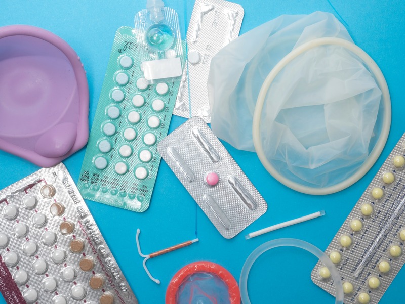 Various different contraceptive methods scattered across a light blue background.