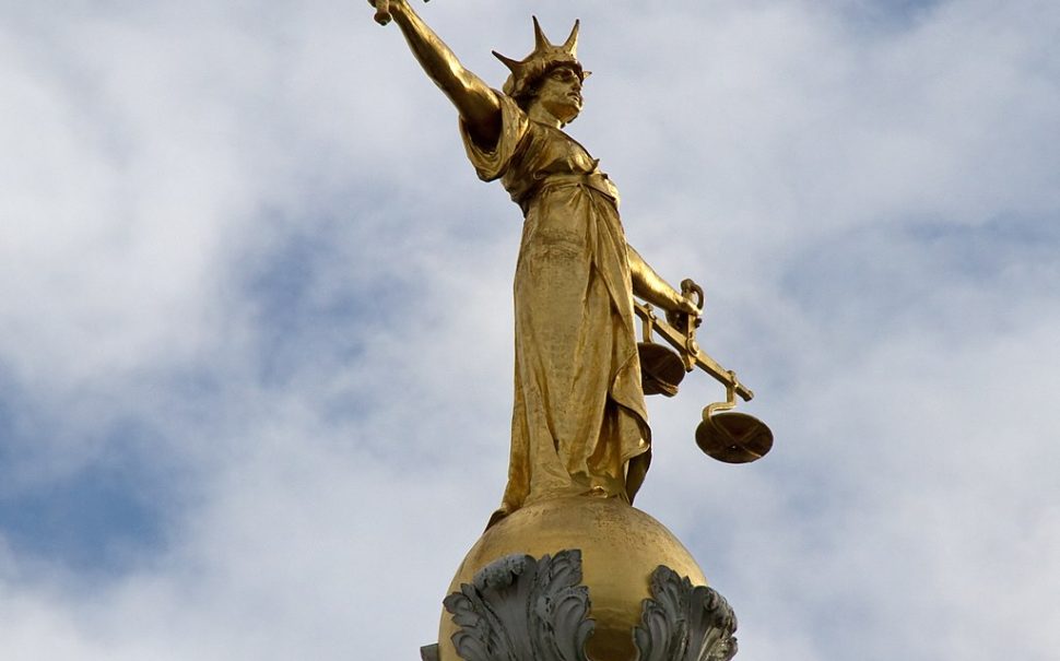 bronze Lady Justice statue on top of the Old Bailey