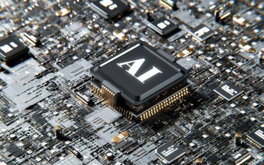 A computer chipboard, with one chip standing out above the rest in the centre of the image, with 'AI' written on it.