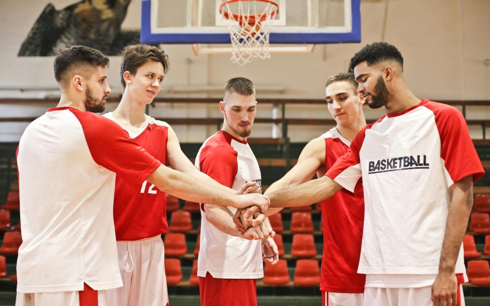 Young basketball players put their hands in during a huddle