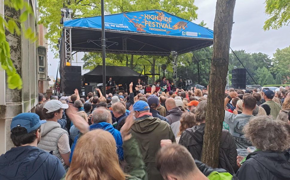 Crowds in front of a High Tide Twickenham stage listening to a band.