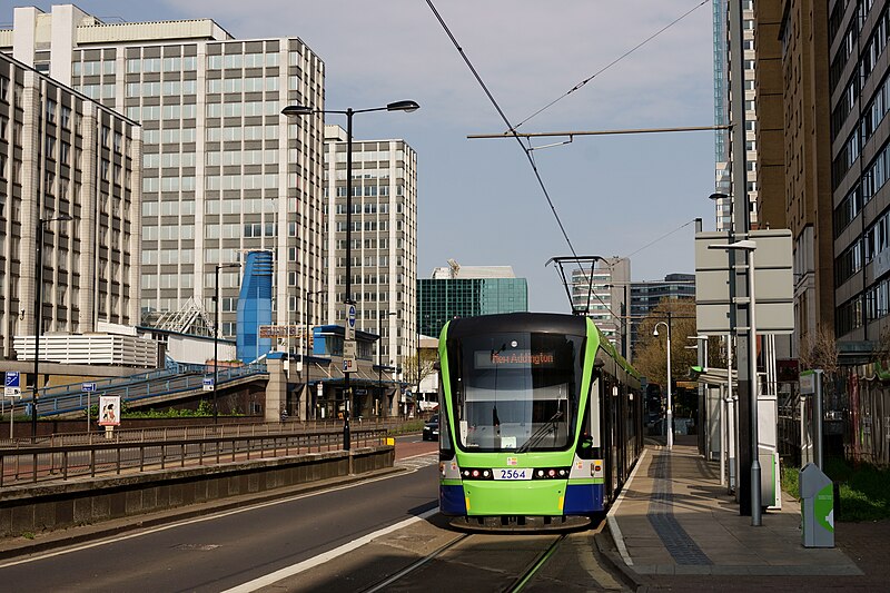 Green tram travels through Croydon