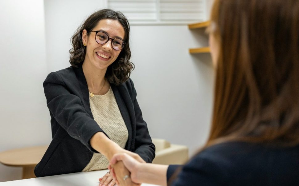 Woman in Business Attire Shaking Hands With Recruiting Manager After Job Interview