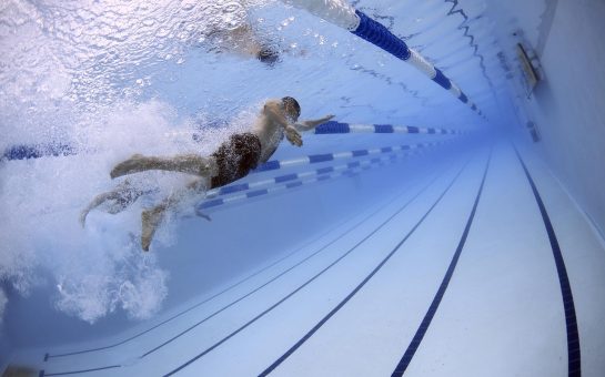 Swimmer swims in pool