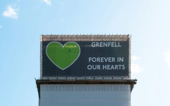 Billboard which reads: "Grenfell, forever in our hearts" next to a green heart.