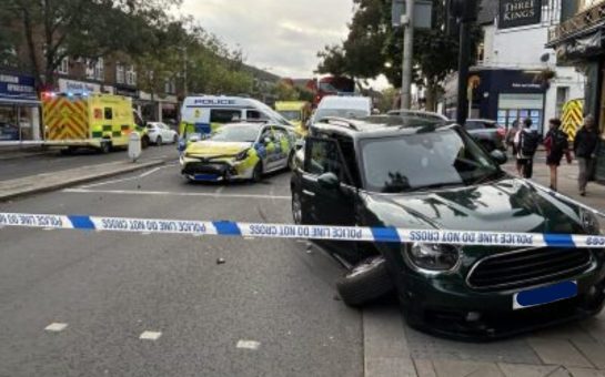 Aftermath of collision between police car and another vehicle