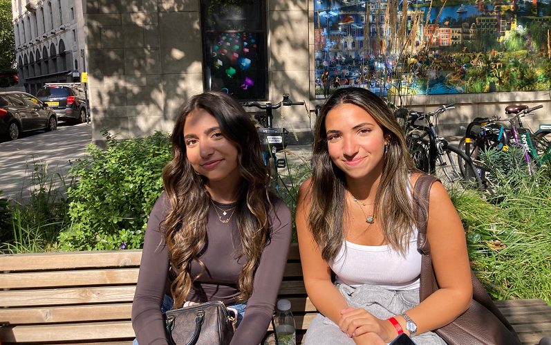 Haya Hamilton  and Malak Hafez sat on a bench.