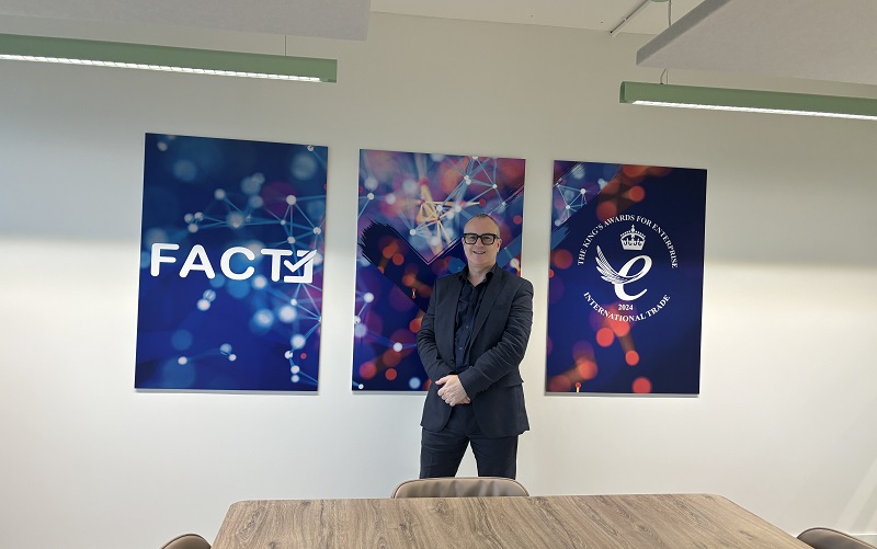 Eddy Leviten stood in front of some FACT posters