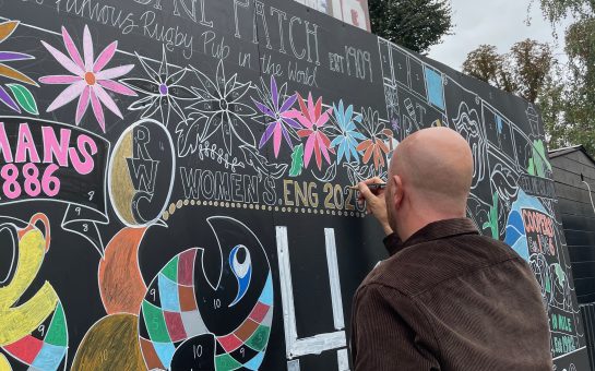 Twickenham's Cabbage Patch Pub manager colouring in a section of the pub's World Mental Health Day paint-by-numbers mural