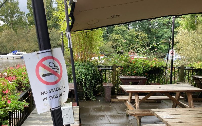 Pub with 'no smoking in this area' sign outdoors