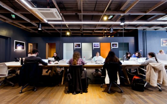 People work around desks at a coworking space in Bromley