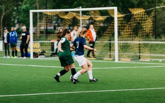 Two girls playing football