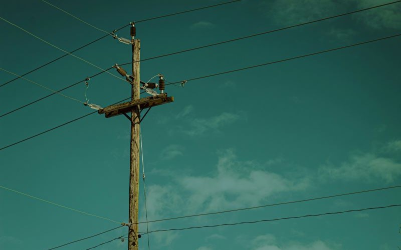 Overhead power lines that transmit electricity over long distances using pylons or towers.