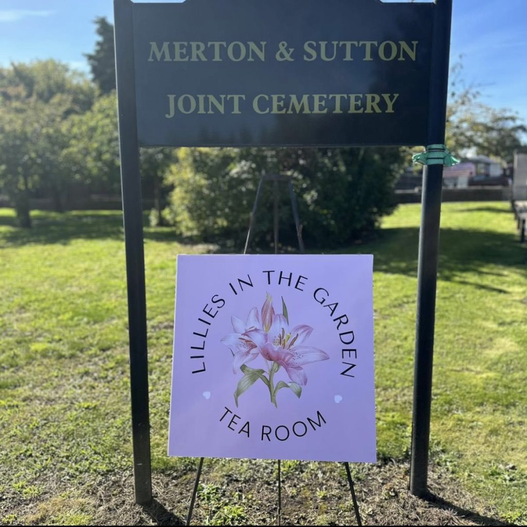 Lillie’s in the Garden tea room sign underneath Merton and Sutton joint cemetery sign