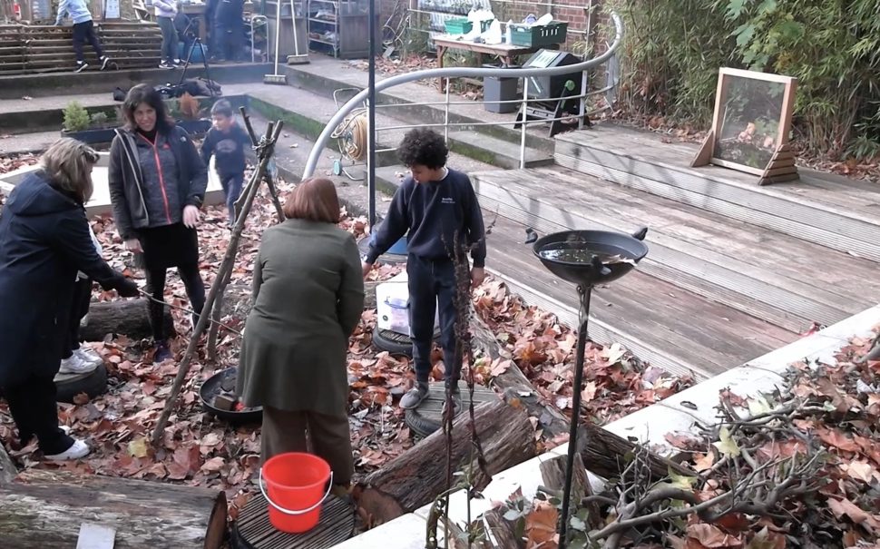 A picture of members of the school round a fire