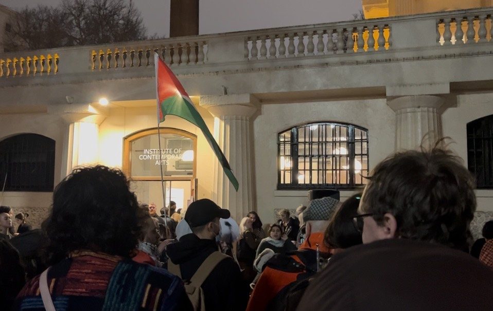 Images show a crowd stood outside the Institute of Contemporary art in Central London. A person holds a Palestinian flag in the background.