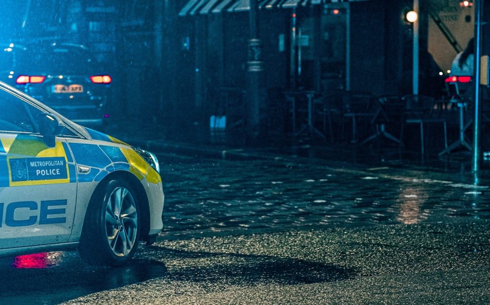 Police car on dark cobbled street