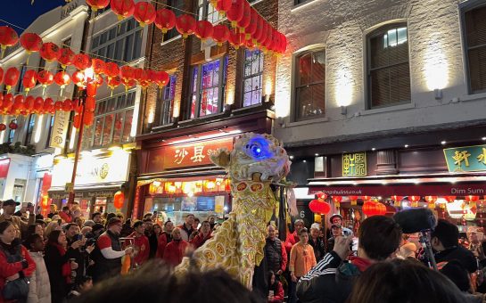 A lion dance show outside a restaurant in Chinatown during their Chinese New Year parade