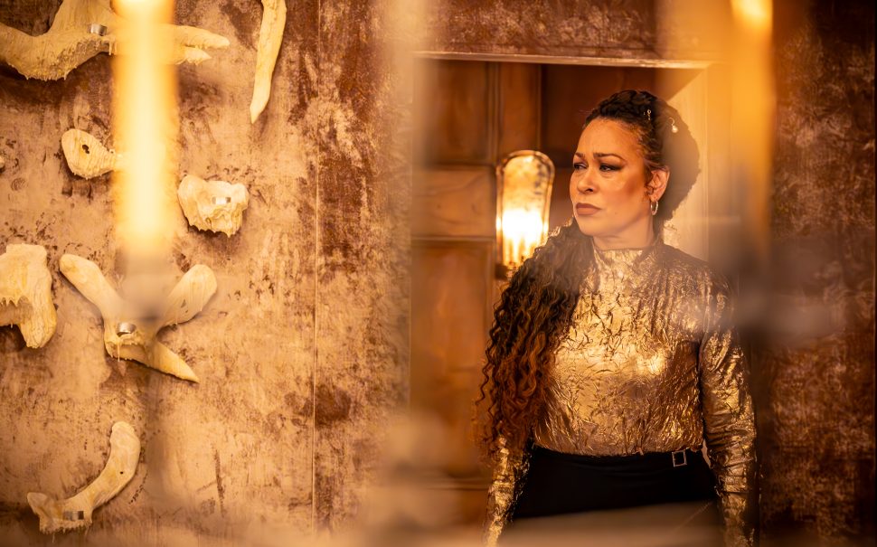 Queen Cymbeline (Martina Laird) on stage at The Globe, dressed in gold, looking powerful.