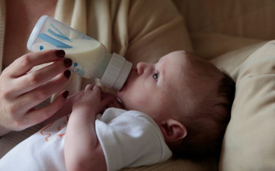 Baby being fed milk