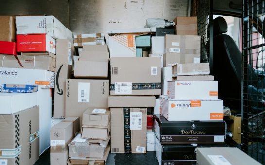 Parcels stacked in the back of a delivery van (Credit: Free to use from Unsplash)